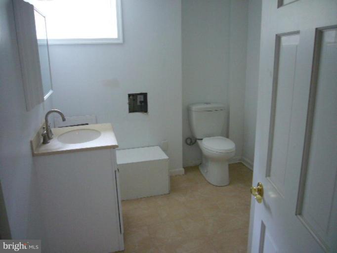 317 Worthington Road Towson, MD 21286 - Photo 11 of 14 a bathroom with a toilet sink and mirror