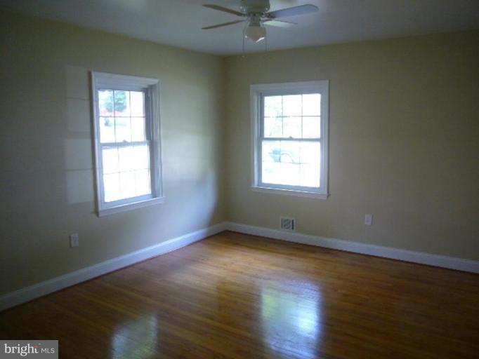 317 Worthington Road Towson, MD 21286 - Photo 4 of 14 an empty room with wooden floor and windows