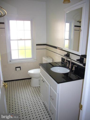 317 Worthington Road Towson, MD 21286 - Photo 7 of 14 a bathroom with a sink a toilet a window and vanity
