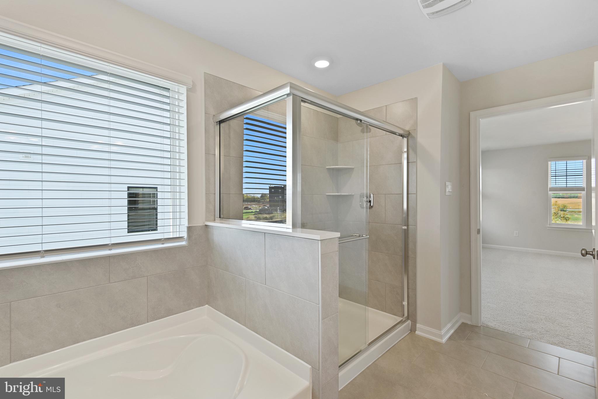 475 Ensemble Way Frederick, MD 21701 - Photo 20 of 25 a bathroom with a bathtub and shower