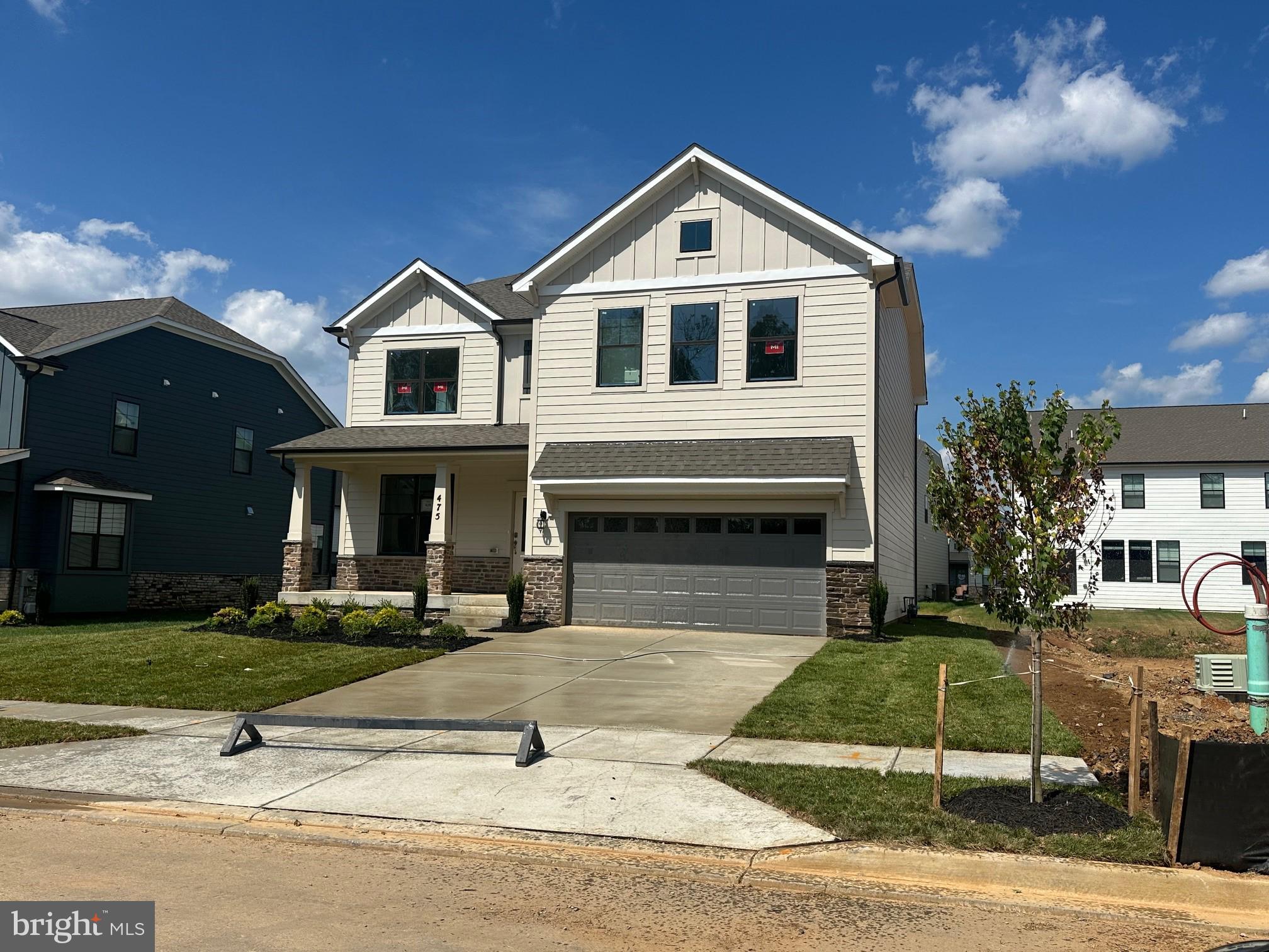 475 Ensemble Way Frederick, MD 21701 - Photo 2 of 25 a front view of a house with a yard