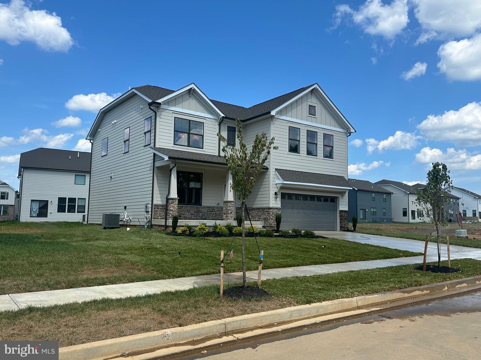 475 Ensemble Way Frederick, MD 21701 - Photo 3 of 25 a front view of a house with a yard