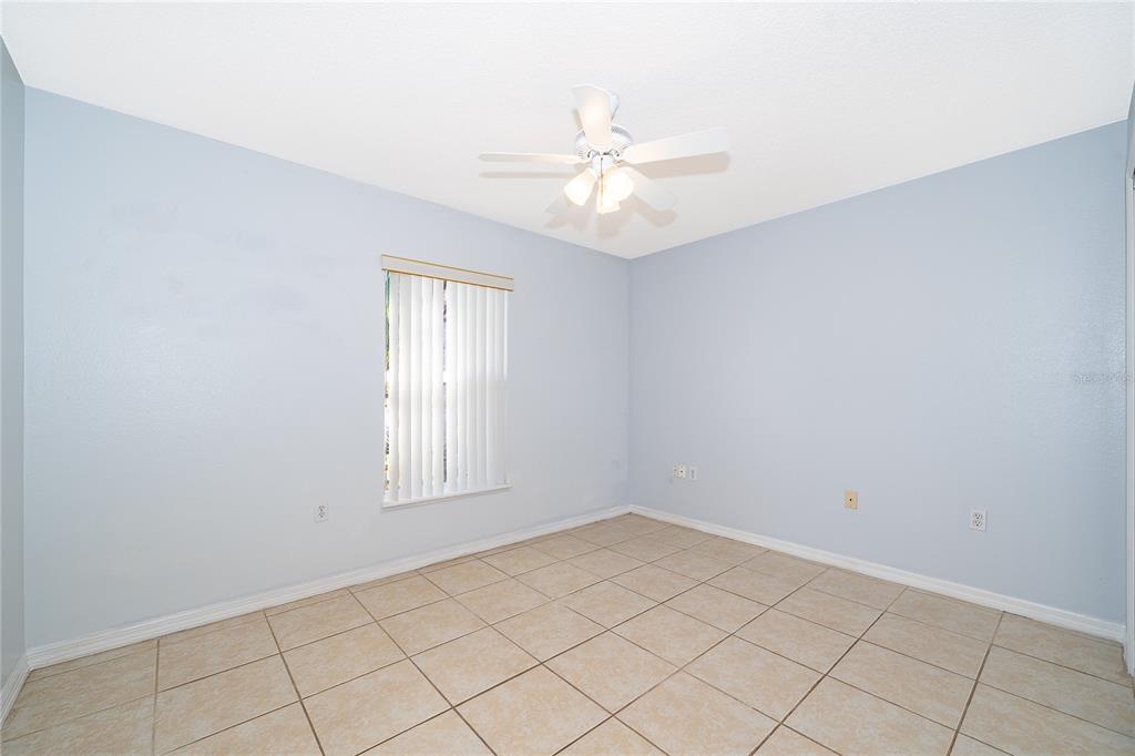 611 Baldwin Drive Kissimmee, FL 34758 - Photo 16 of 26 an empty room with windows and fan