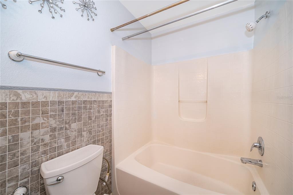 611 Baldwin Drive Kissimmee, FL 34758 - Photo 18 of 26 a white bath tub sitting next to a white toilet