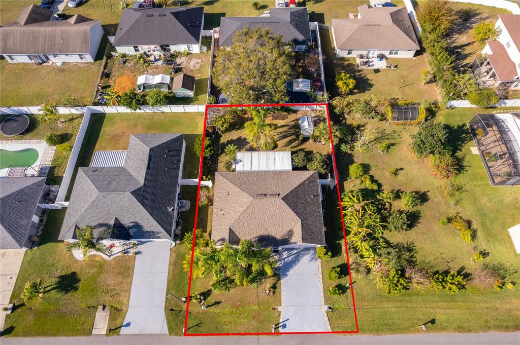 611 Baldwin Drive Kissimmee, FL 34758 - Photo 23 of 26 an aerial view of a house with a yard swimming pool and large trees