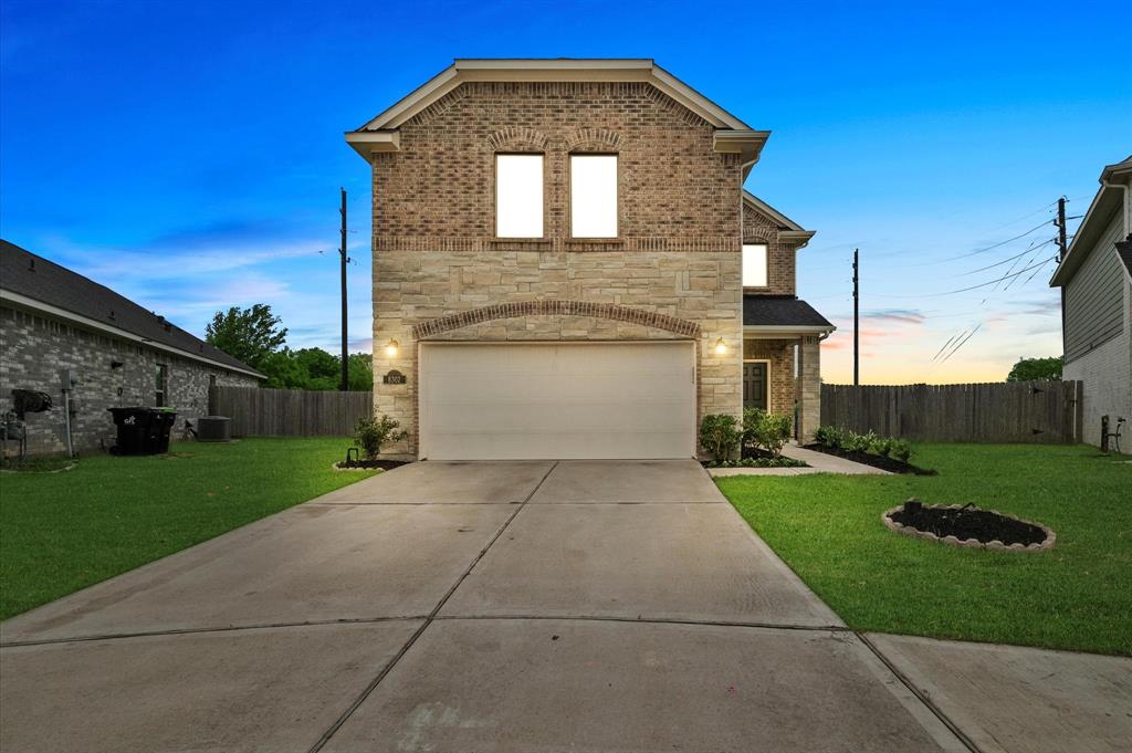 8302 Balding Drive Fulshear, TX 77441 - Photo 1 of 50 a front view of a house with a yard