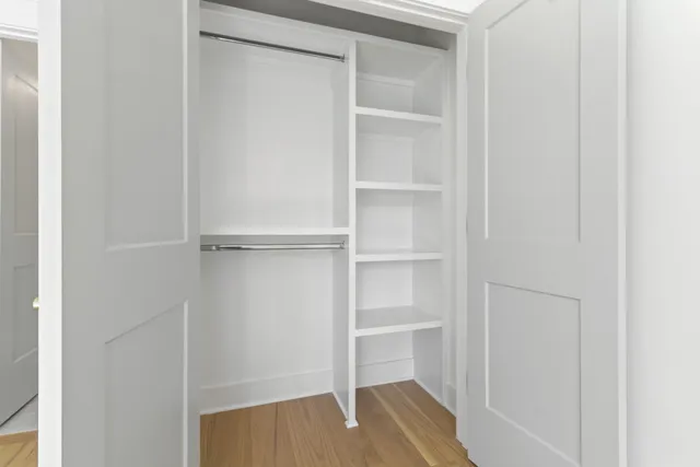 a view of walk in closet with empty racks