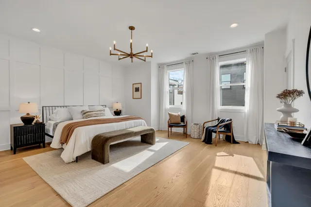 a spacious bedroom with a bed a couch and dresser