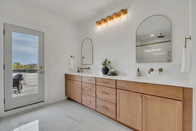 a view of a terrace with couches and lounge chairs