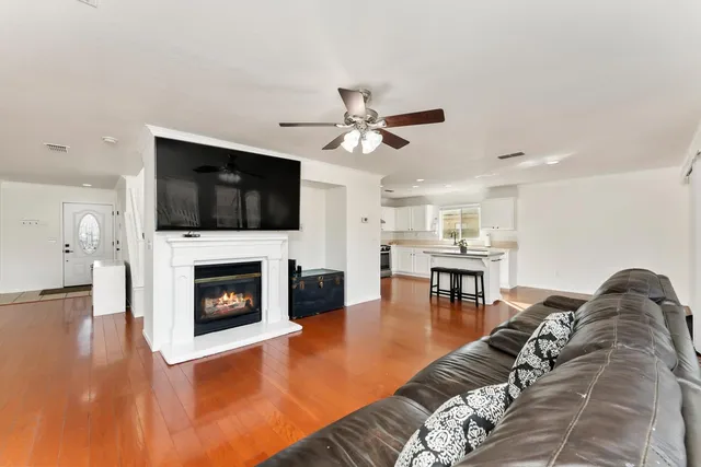 a living room with furniture a fireplace and a flat screen tv