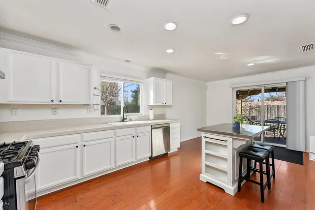 a kitchen with sink and cabinets