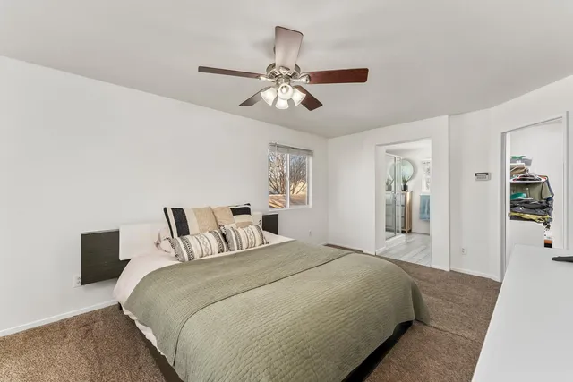 a bedroom with a large bed and a chandelier