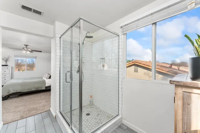 a bathroom with a shower and a sink