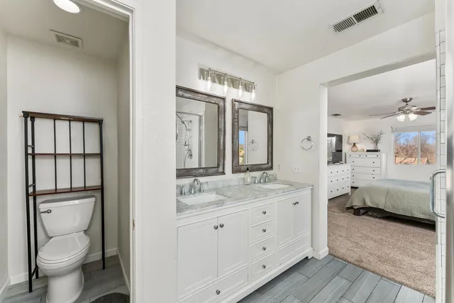 a spacious bathroom with a granite countertop sink toilet and shower