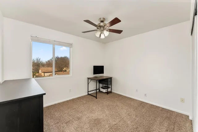 a room with a dresser and a chandelier