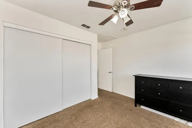 a bathroom with a granite countertop toilet a sink and a mirror