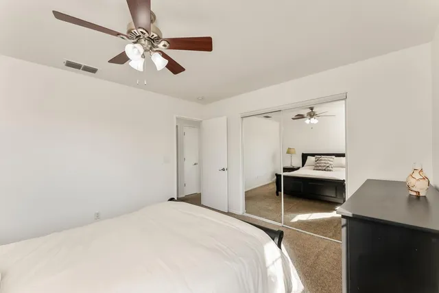 a view of a porch with chairs and a potted plant