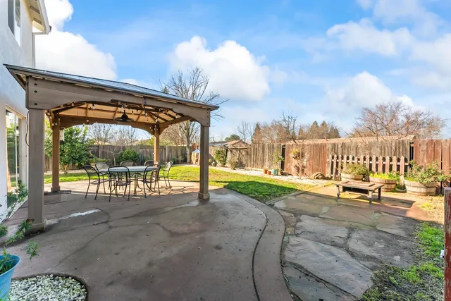 a view of a swimming pool with an outdoor seating and a yard