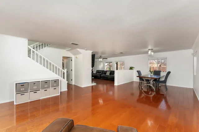 a dining room with furniture and wooden floor