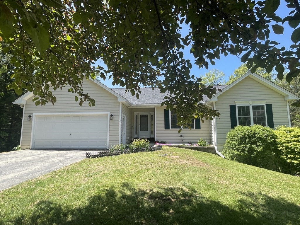 32 Jericho Road Rindge, NH 03461 - Photo 1 of 37 a front view of a house with yard and trees