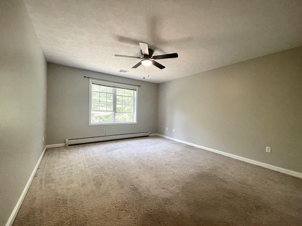 32 Jericho Road Rindge, NH 03461 - Photo 13 of 37 an empty room with windows and ceiling fan