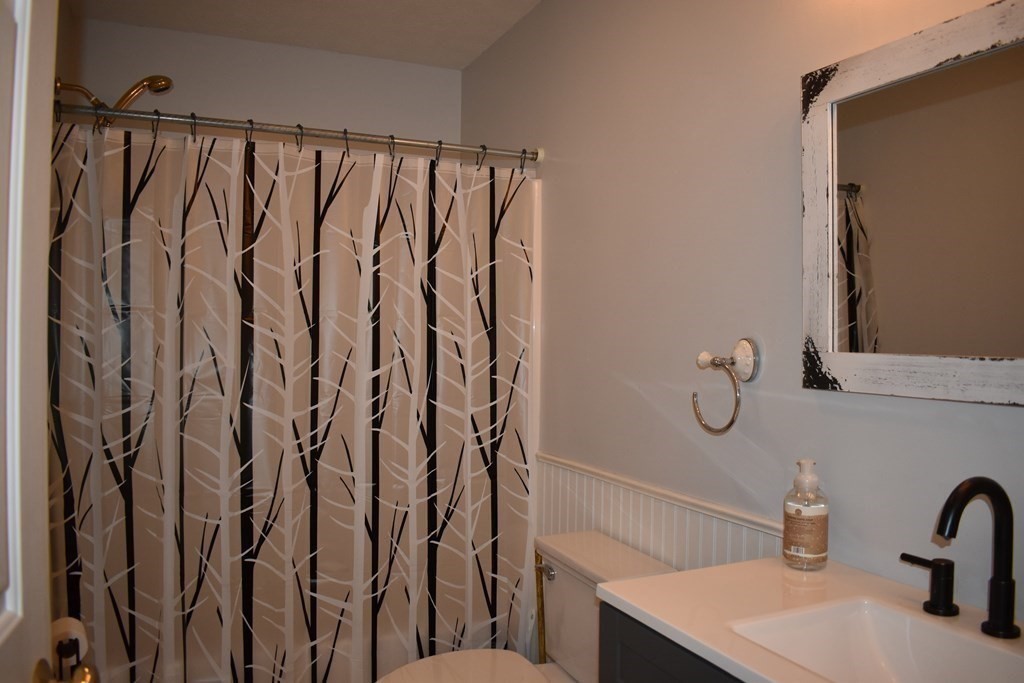 32 Jericho Road Rindge, NH 03461 - Photo 19 of 37 a bathroom with a shower curtain and a sink