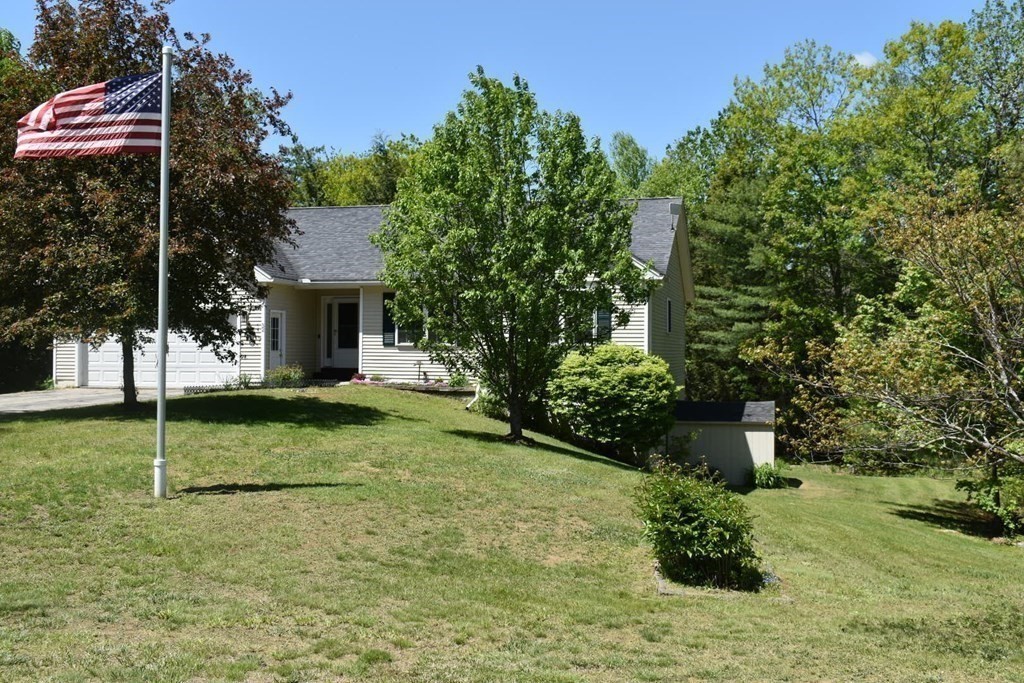 32 Jericho Road Rindge, NH 03461 - Photo 36 of 37 a backyard of a house with plants and tree