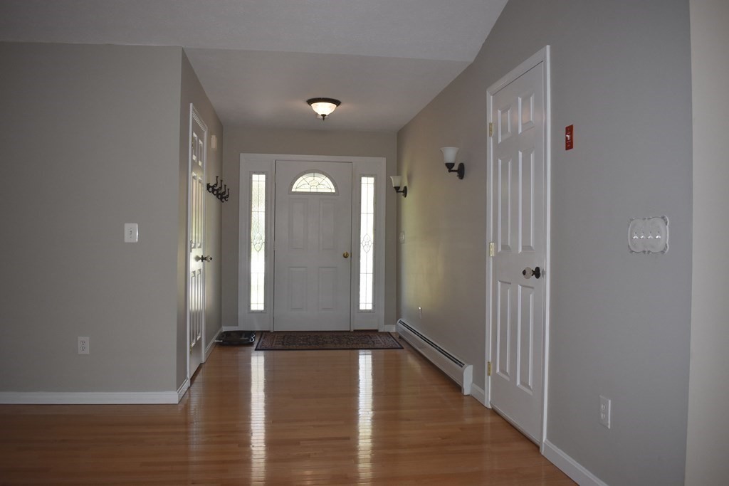 32 Jericho Road Rindge, NH 03461 - Photo 6 of 37 a view of a hallway with wooden floor and staircase