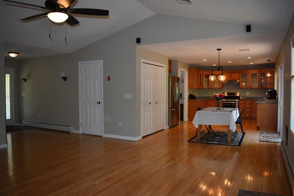 32 Jericho Road Rindge, NH 03461 - Photo 7 of 37 an empty room with wooden floor and way to kitchen