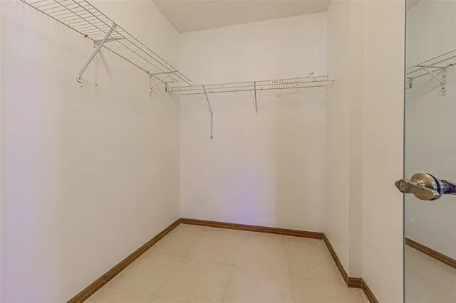 a view of a hallway with chandelier and a window
