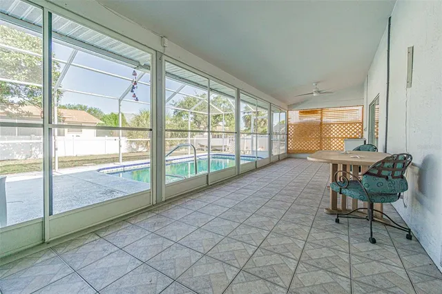 a view of a room with furniture and a large window