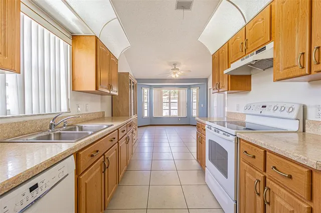 a large kitchen with a sink and cabinets