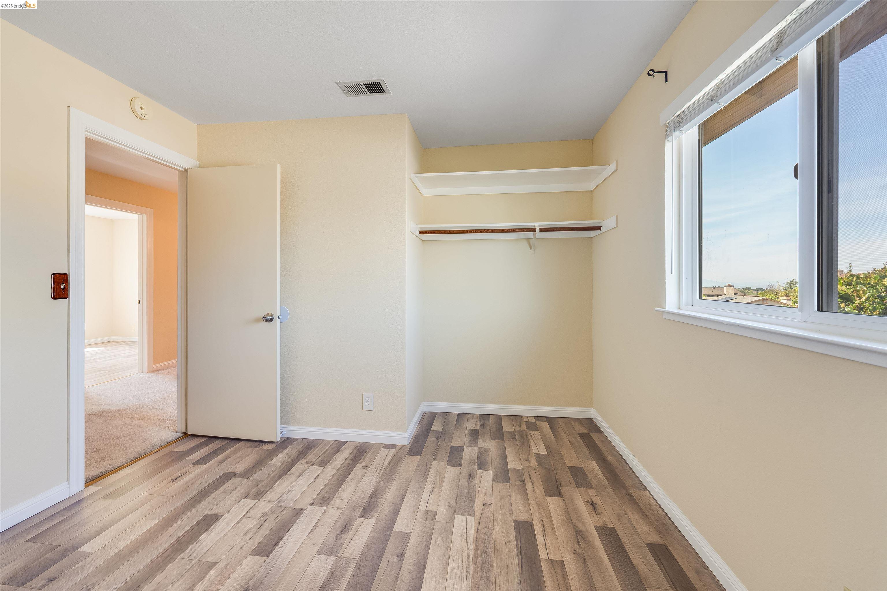 2142 Redwood Road Hercules, CA 94547 - Photo 24 of 37 Unfurnished bedroom with light wood-style floors and a closet