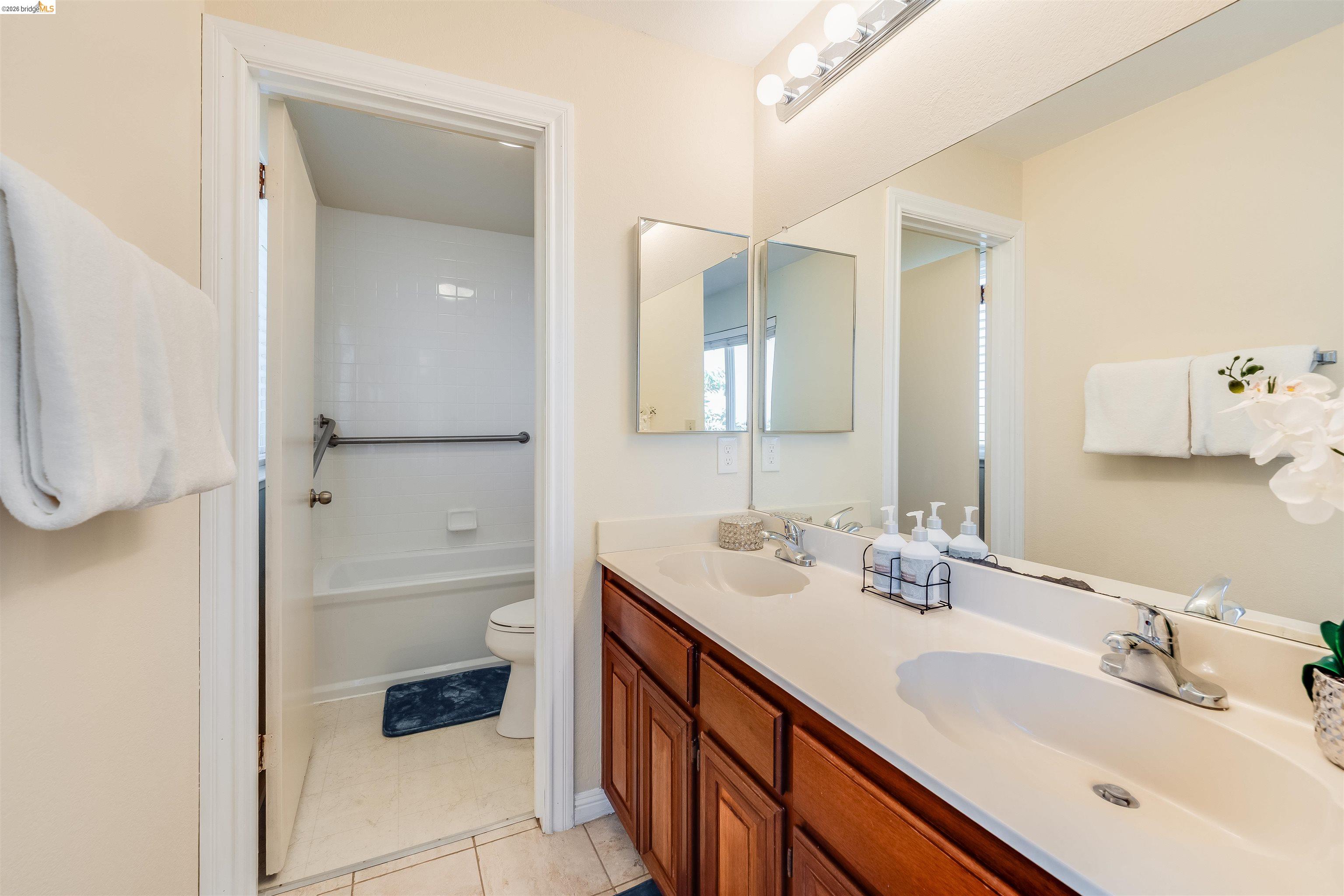 2142 Redwood Road Hercules, CA 94547 - Photo 28 of 37 Full bathroom with double vanity and light tile patterned floors