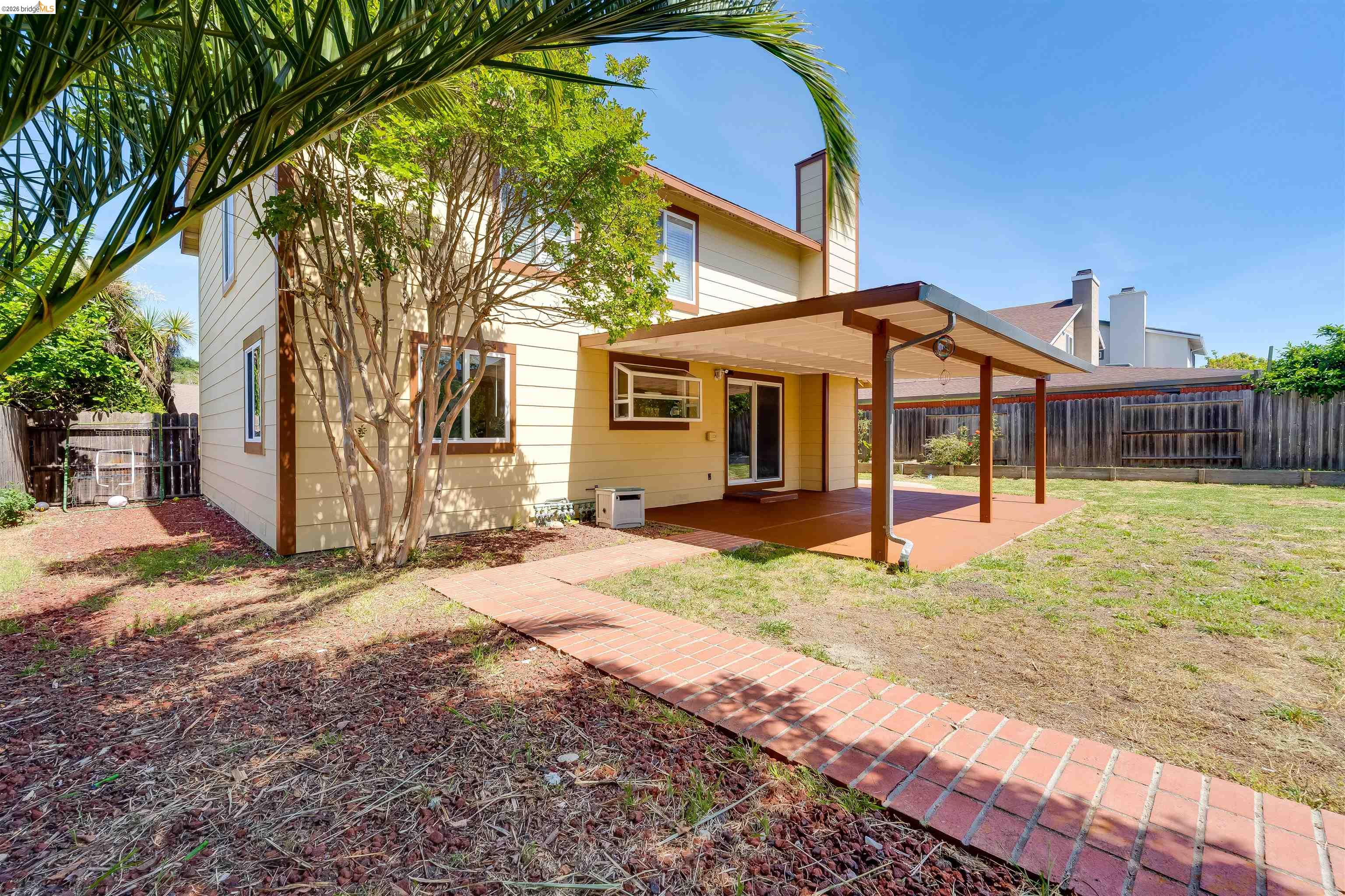 2142 Redwood Road Hercules, CA 94547 - Photo 36 of 37 Back of property featuring a fenced backyard, a patio area, and a chimney