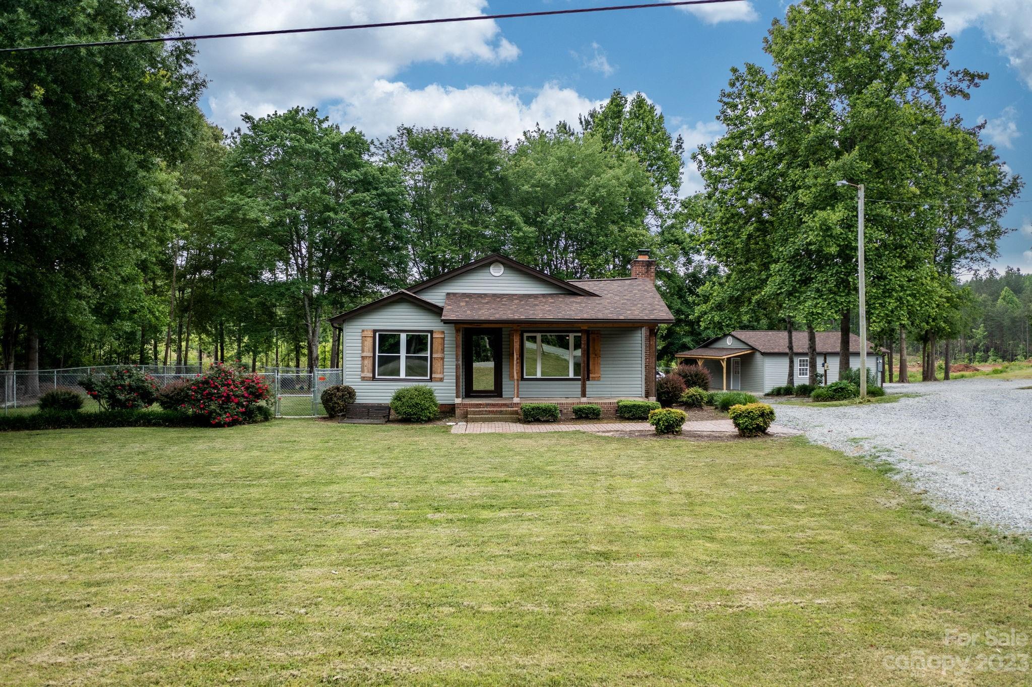 a view of a house with garden and sitting area