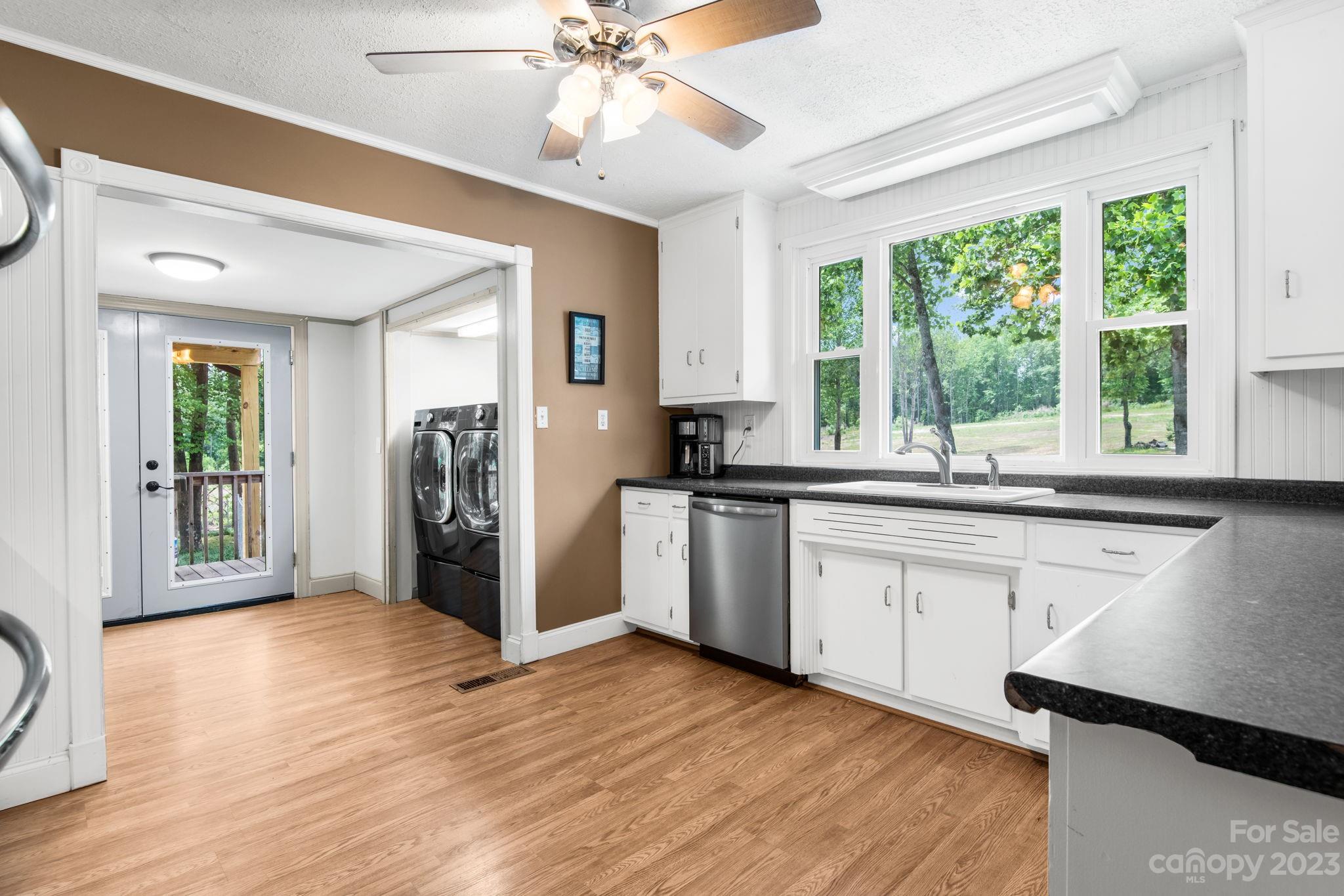 1335 Hill Road Lincolnton, NC 28092 - Photo 18 of 38 a kitchen with stainless steel appliances granite countertop a refrigerator a sink dishwasher a stove and white countertops with wooden floor