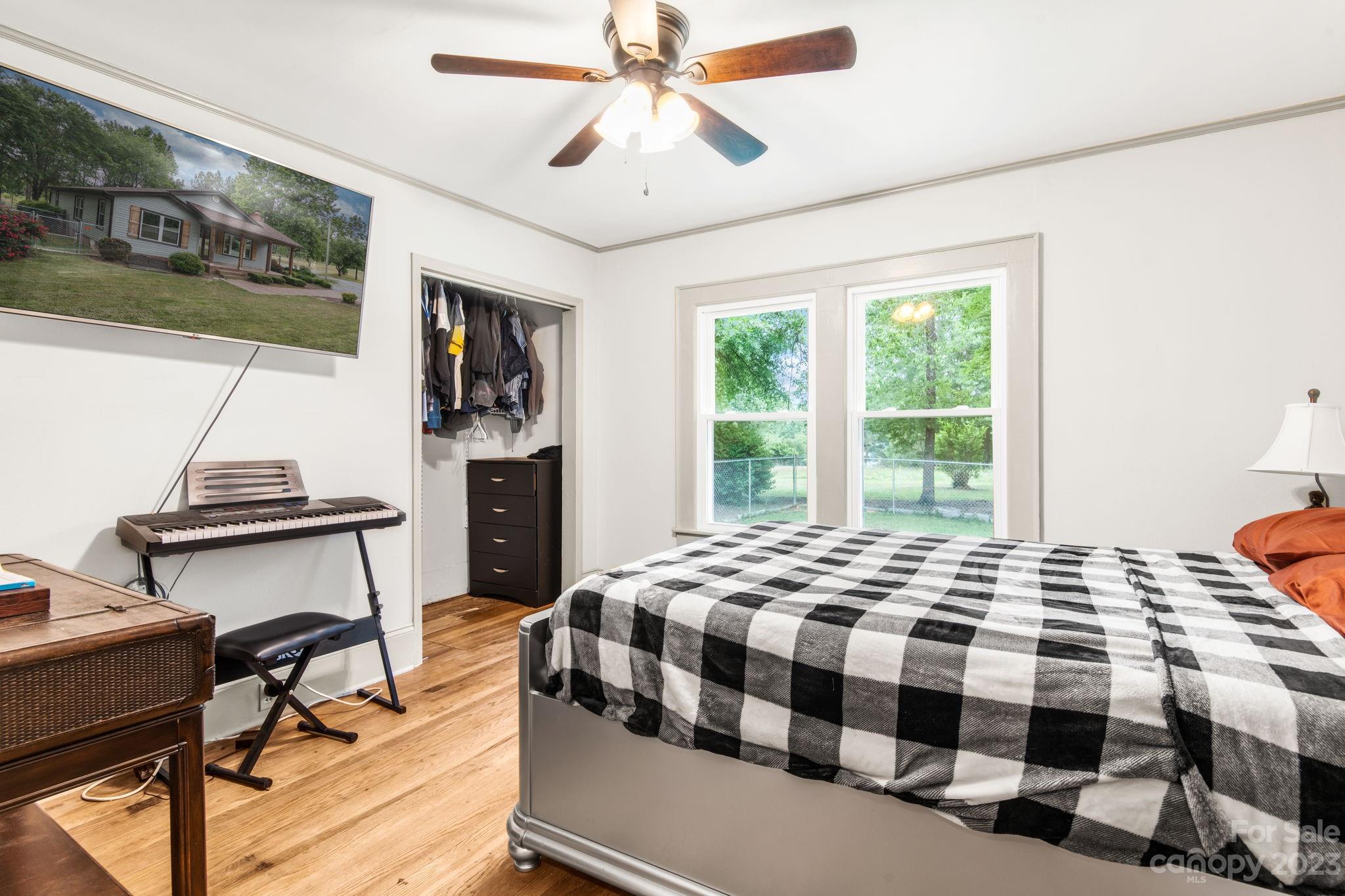 1335 Hill Road Lincolnton, NC 28092 - Photo 26 of 38 a bedroom with a bed and a chandelier
