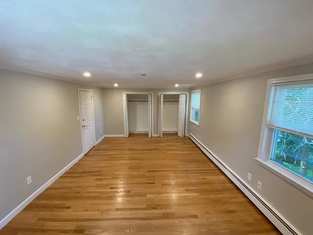 a view of hallway with wooden floor