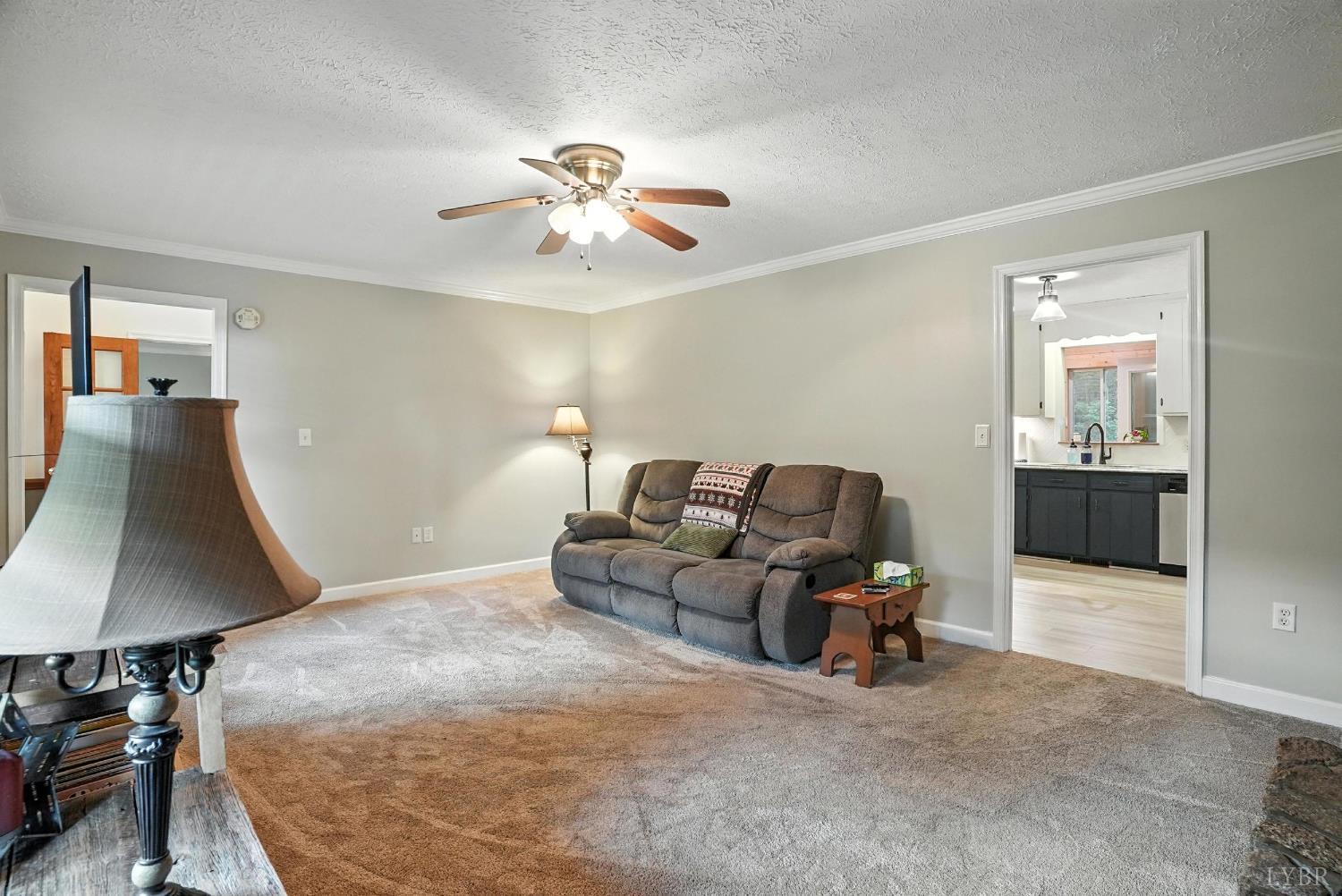 69 Gough Road Rustburg, VA 24588 - Photo 14 of 61 a living room with furniture and a lamp