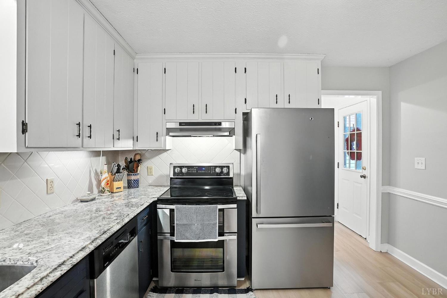 69 Gough Road Rustburg, VA 24588 - Photo 23 of 61 a kitchen with refrigerator a stove a sink and cabinets