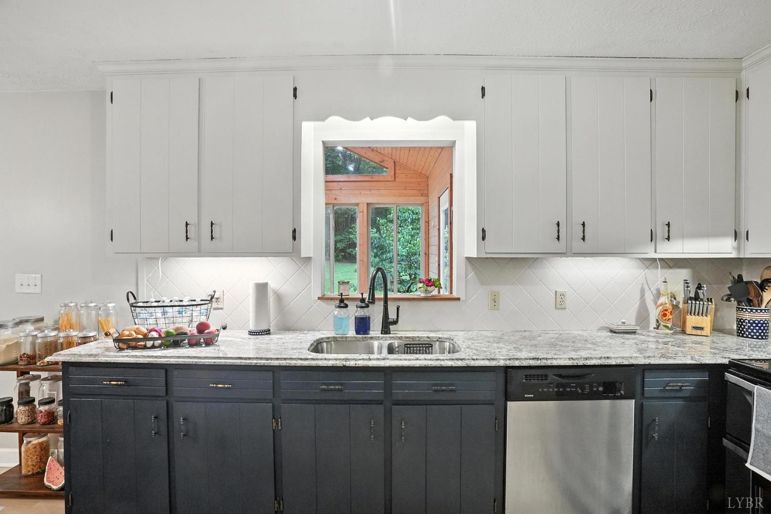 69 Gough Road Rustburg, VA 24588 - Photo 24 of 61 a kitchen with granite countertop white cabinets white appliances a sink and dishwasher