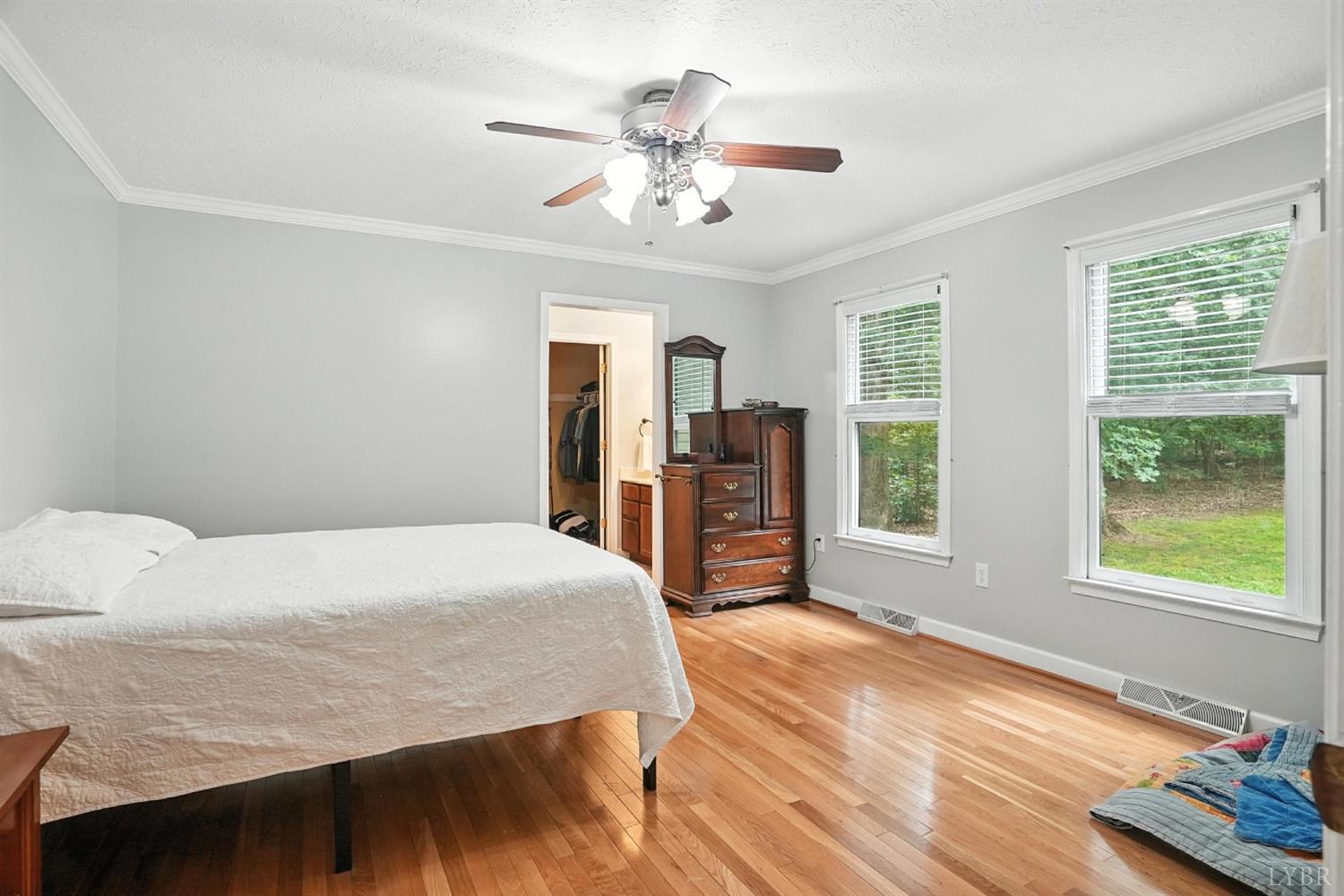 69 Gough Road Rustburg, VA 24588 - Photo 30 of 61 a bedroom with a large bed and a chandelier