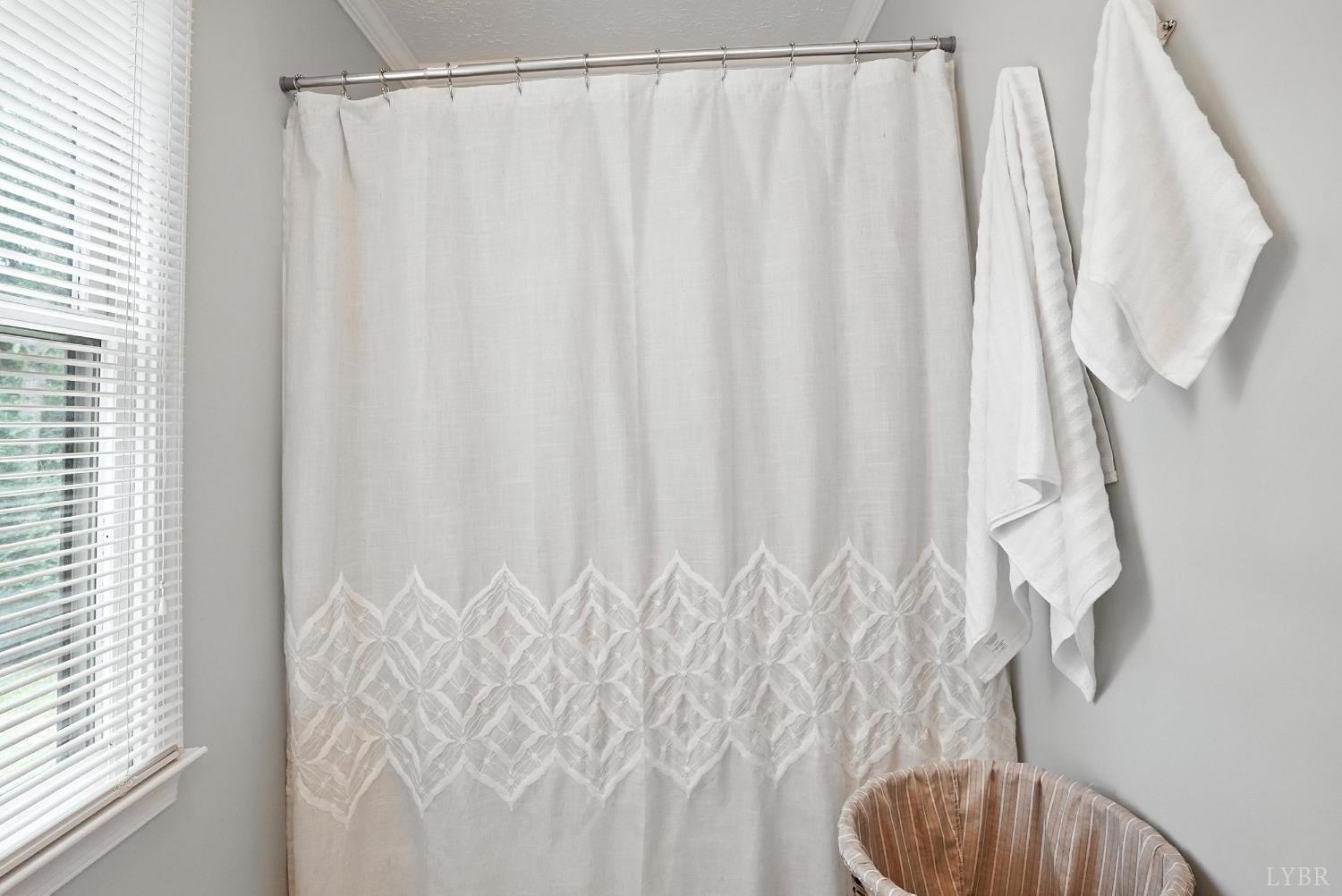 69 Gough Road Rustburg, VA 24588 - Photo 34 of 61 a bathroom with a shower curtain and a curtain