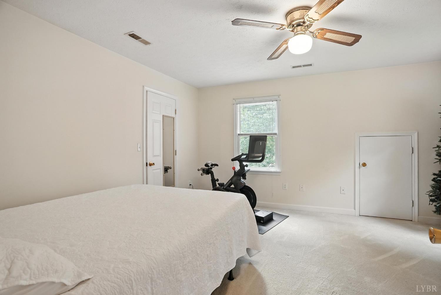 69 Gough Road Rustburg, VA 24588 - Photo 38 of 61 a bedroom with a bed and a chandelier