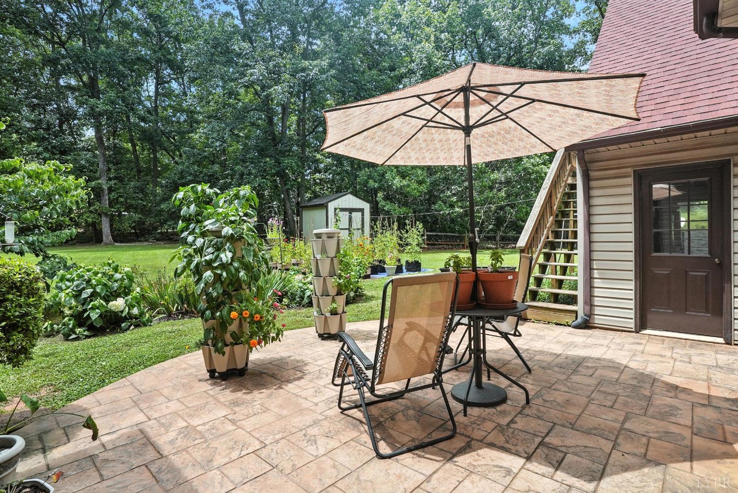 69 Gough Road Rustburg, VA 24588 - Photo 5 of 61 a view of a patio with a table and chairs under an umbrella