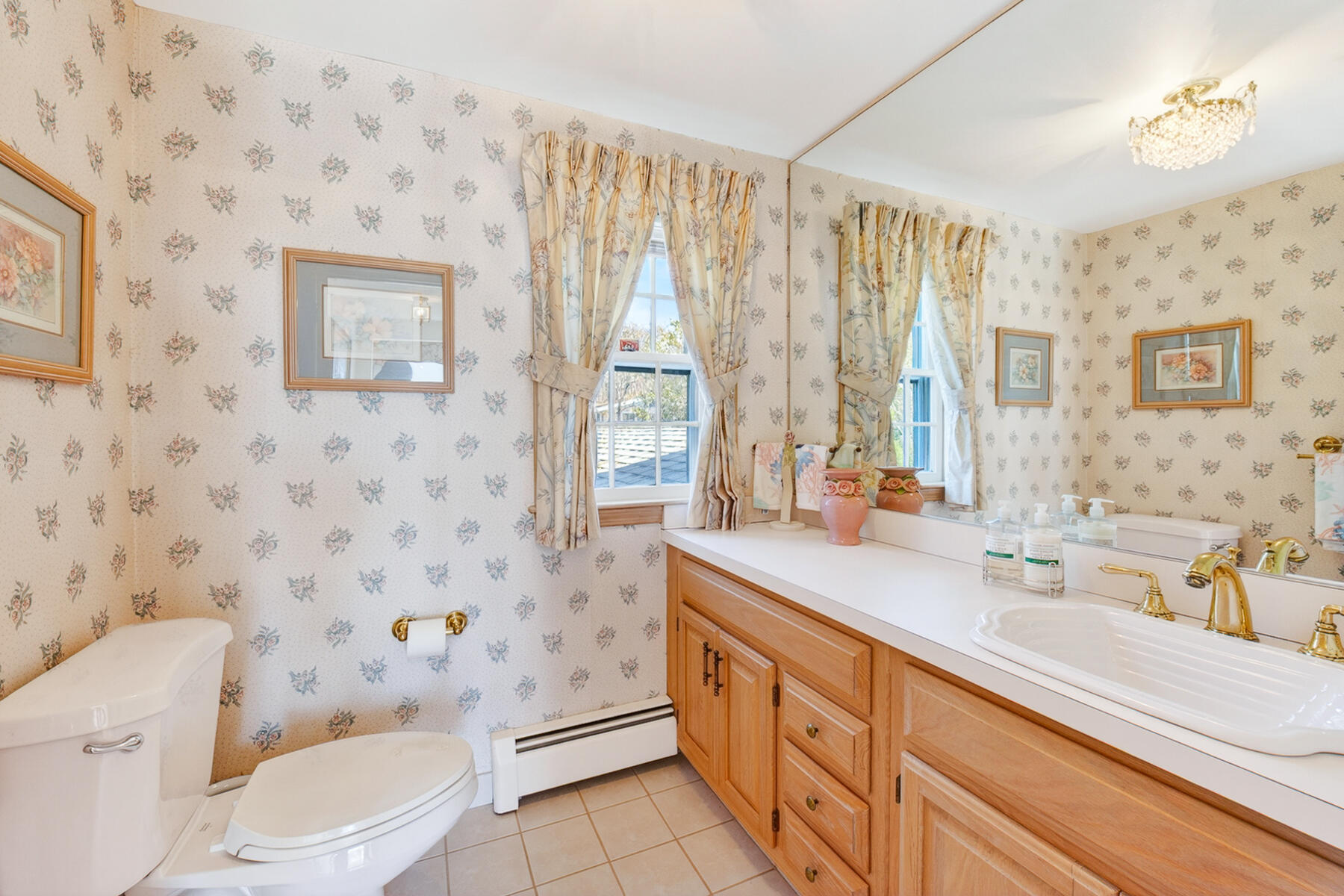 38 Nemasket Road Falmouth, MA 02540 - Photo 25 of 59 a bathroom with a sink a toilet a mirror and shower