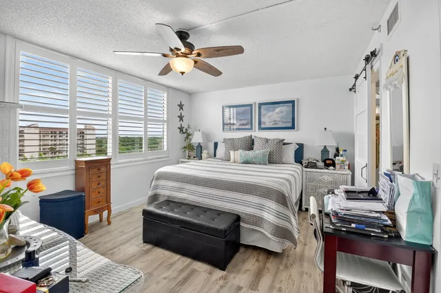 a bedroom with a bed and a desk