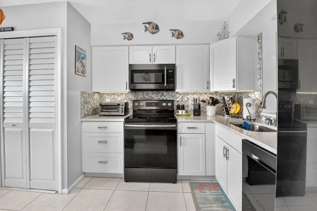 a kitchen with stainless steel appliances granite countertop a stove and a refrigerator