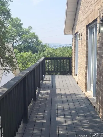 a view of balcony with wooden floor